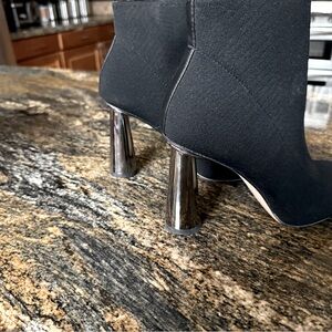 Black, soft material boots with stunning silver heel